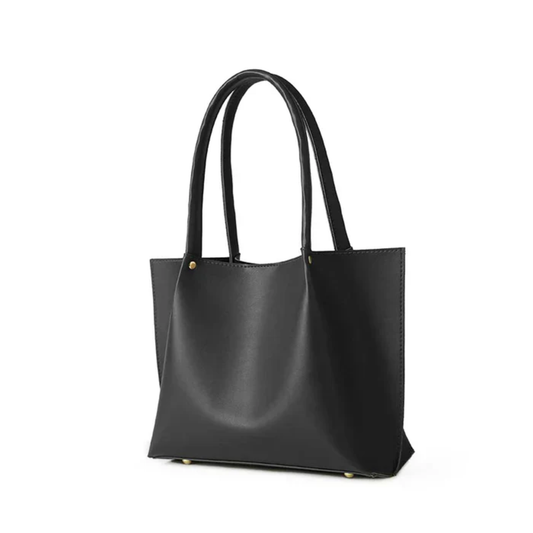 Black handmade leather tote bag with long handles on a white background